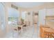 Kitchen nook with a table and chairs set by a window, bright neutral paint, and access to the laundry room at 3231 Furlong Way, Gotha, FL 34734