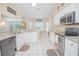 Kitchen featuring white cabinets, granite countertops, stainless steel appliances, and tile flooring at 3231 Furlong Way, Gotha, FL 34734