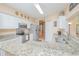 Bright kitchen featuring white cabinets, granite countertops, and stainless steel appliances at 3231 Furlong Way, Gotha, FL 34734