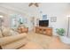 Open-concept living room with light-colored walls, wood floors, a ceiling fan, and comfortable seating at 3231 Furlong Way, Gotha, FL 34734