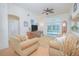 Bright living room with a ceiling fan, neutral-colored furniture, and view of the pool through the sliding glass doors at 3231 Furlong Way, Gotha, FL 34734