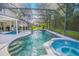 Stunning in-ground pool and spa enclosed within a screened lanai, ideal for outdoor enjoyment at 3231 Furlong Way, Gotha, FL 34734