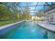 Inviting screened-in pool with a spillover spa and a spacious deck for relaxing and entertaining outdoors at 3231 Furlong Way, Gotha, FL 34734