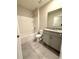 A stylish bathroom features a granite-topped vanity, sleek gray cabinets, and modern fixtures at 324 Charles Dr, Deland, FL 32724