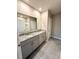 Bathroom featuring double granite vanity with sinks, a large mirror, and tile floors at 324 Charles Dr, Deland, FL 32724
