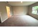 Comfortable bedroom with plush carpeting and a large window offering natural light at 324 Charles Dr, Deland, FL 32724