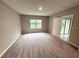 Comfortable bedroom with plush carpeting and a large window offering natural light at 324 Charles Dr, Deland, FL 32724