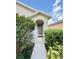 Inviting front entrance with a sheltered doorway and neatly trimmed bushes adding curb appeal to the home at 324 Charles Dr, Deland, FL 32724