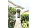 Inviting front entrance with a covered porch, complemented by lush landscaping at 324 Charles Dr, Deland, FL 32724
