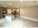 Spacious kitchen featuring an island with a granite countertop, stainless steel appliances, and ample storage at 324 Charles Dr, Deland, FL 32724