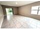 Bright living room with large windows and sliding door, offering plenty of natural light and tile floors at 324 Charles Dr, Deland, FL 32724