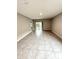 Bright living room with large windows and sliding door, offering plenty of natural light and tile floors at 324 Charles Dr, Deland, FL 32724