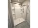 Modern walk-in shower features a sleek design with a detachable shower head and convenient built-in shelves at 324 Charles Dr, Deland, FL 32724