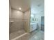 Elegant bathroom features a tiled shower with a glass door at 3381 Sw 129Th Loop, Ocala, FL 34473