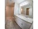 Bathroom features a double sink vanity with white cabinetry and a large mirror at 3381 Sw 129Th Loop, Ocala, FL 34473