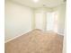 Bedroom featuring carpeted floors, neutral walls, a closet, and an entry door at 3381 Sw 129Th Loop, Ocala, FL 34473