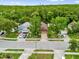A bird's eye view of a tree-lined residential street with single-Gathering homes and manicured lawns at 3390 Cypress Point Cir, St Cloud, FL 34772