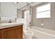Bathroom featuring a vanity, toilet, and tub with a window for natural light at 3390 Cypress Point Cir, St Cloud, FL 34772
