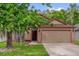 Charming single-story home with a well-maintained lawn and a two-car garage at 3390 Cypress Point Cir, St Cloud, FL 34772