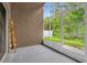 Enclosed patio with concrete flooring, providing an outdoor living space and nature views at 3390 Cypress Point Cir, St Cloud, FL 34772