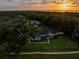 Aerial view of an estate with mature trees and beautiful landscaping at sunset at 340 Lakeview Rd, Winter Garden, FL 34787