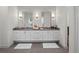 Stylish bathroom featuring double vanity with modern lighting, gray tile floors and white shiplap walls at 340 Lakeview Rd, Winter Garden, FL 34787