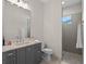 Bathroom featuring gray vanity, single sink, mirror, walk-in shower, and tile floors at 340 Lakeview Rd, Winter Garden, FL 34787