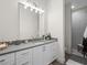 Bright bathroom with a white vanity and an open door to another bathroom area at 340 Lakeview Rd, Winter Garden, FL 34787