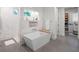 Bright bathroom with modern tub, white marble tile walls, and a view to walk-in closet at 340 Lakeview Rd, Winter Garden, FL 34787