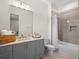 Modern bathroom featuring a vanity with a marble countertop, gray cabinets and a shower over tub at 340 Lakeview Rd, Winter Garden, FL 34787
