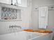Close up on modern soaking tub featuring bamboo tray, chrome faucet, and decorative marble inset at 340 Lakeview Rd, Winter Garden, FL 34787