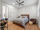 This bedroom features a wood bed frame, wood floors, shiplap accent wall and neutral colors at 340 Lakeview Rd, Winter Garden, FL 34787