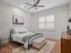 This bedroom features a metal bed frame, wood floors, shiplap accent wall and neutral colors at 340 Lakeview Rd, Winter Garden, FL 34787