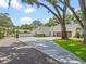Long, paved driveway leading to a white farmhouse-style home with a three-car garage at 340 Lakeview Rd, Winter Garden, FL 34787