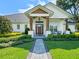 Welcoming front entrance with a paved walkway, wood-accented porch, and manicured landscaping at 340 Lakeview Rd, Winter Garden, FL 34787