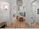 Hallway with beautiful millwork details that leads into a bright and open living area with beamed ceilings at 340 Lakeview Rd, Winter Garden, FL 34787