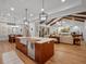 Open-concept kitchen and living room featuring wood beams, a large island, and modern lighting at 340 Lakeview Rd, Winter Garden, FL 34787