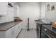 Bright laundry room with gray countertops, patterned tile floors, front-load washer, and dryer at 340 Lakeview Rd, Winter Garden, FL 34787