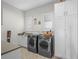 Well-equipped laundry room features washer, dryer, and built-in storage at 340 Lakeview Rd, Winter Garden, FL 34787