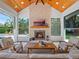 Inviting living room with a brick fireplace, wood ceiling, and views of the backyard at 340 Lakeview Rd, Winter Garden, FL 34787