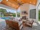 Beautiful indoor/outdoor living space with wood-burning fireplace and views of the pool and backyard at 340 Lakeview Rd, Winter Garden, FL 34787