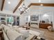 Inviting living room featuring a fireplace, wood beams, and large sliding glass doors with natural light at 340 Lakeview Rd, Winter Garden, FL 34787