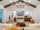 Spacious living room with a modern fireplace, wood beams, and stylish chandelier at 340 Lakeview Rd, Winter Garden, FL 34787