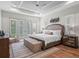Beautiful bedroom featuring tray ceiling, ceiling fan, area rug, and French doors to outdoors at 340 Lakeview Rd, Winter Garden, FL 34787