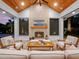 Elegant outdoor living room featuring a fireplace and comfortable seating at 340 Lakeview Rd, Winter Garden, FL 34787