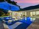 Enjoy this inviting pool area with a sun lounge and clear blue water at 340 Lakeview Rd, Winter Garden, FL 34787
