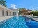 Sparkling pool with an adjacent spa, lounge chairs, and pergola for shade, surrounded by lush landscaping at 340 Lakeview Rd, Winter Garden, FL 34787