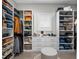 Organized walk-in closet with custom shelving, cabinets, and a cozy stool at 340 Lakeview Rd, Winter Garden, FL 34787