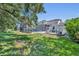 Large lush private backyard, surrounded by mature trees, features a large screened-in pool at 384 Old Alemany Pl, Oviedo, FL 32765