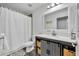Bathroom with modern vanity, basket storage, tile floors, shower, and white sink at 384 Old Alemany Pl, Oviedo, FL 32765